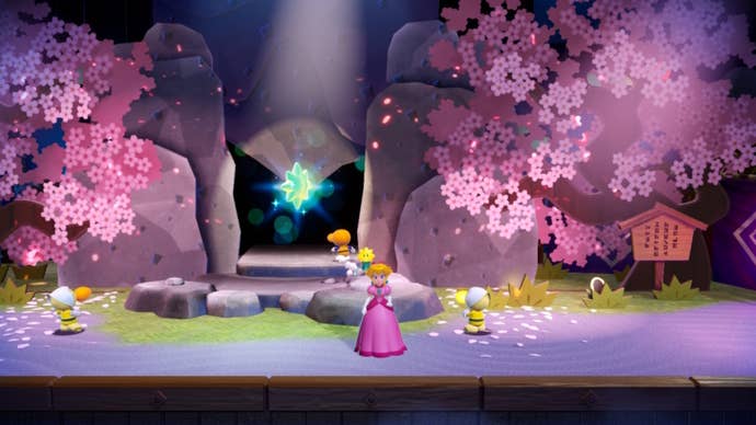 Peach illuminates two cherry blossom trees to reveal a cave and Sparkle Gem in Princess Peach: Showtime