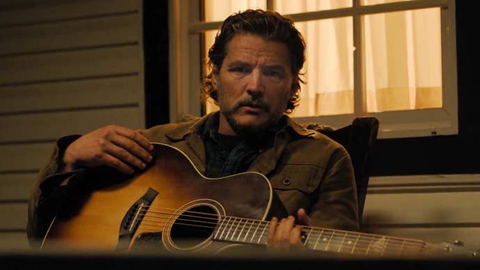 Pedro Pascal as Joel in The Last of Us season two holding a guitar