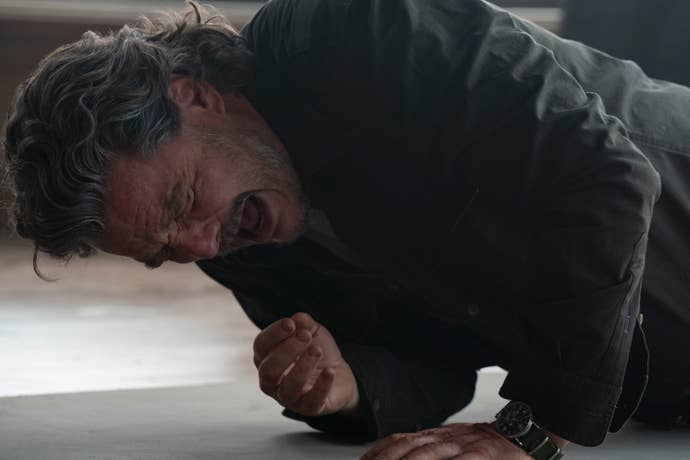 Pedro Pascal as Joel in second episode of the last of us season two. He is writhing in pain