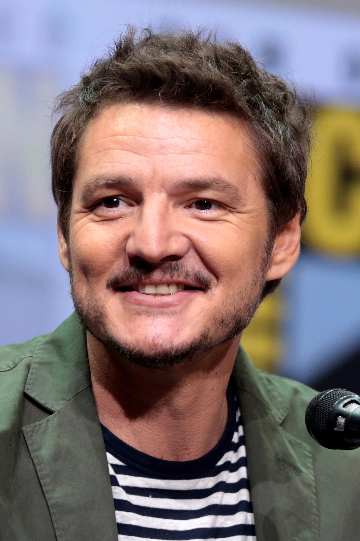 A portrait of Pedro Pascal, smiling handsomely. - 2