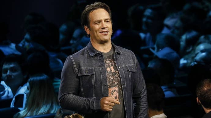 Microsoft executive Phil Spencer in a denim jacket and T-shirt addressing a crowd
