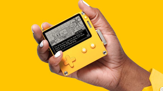 Playdate console being held aloft against a bright yellow background