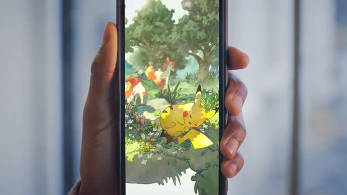 Pokemon Trading Card Game Pocket showing sleeping Pikachu in immersive card held on a mobile screen