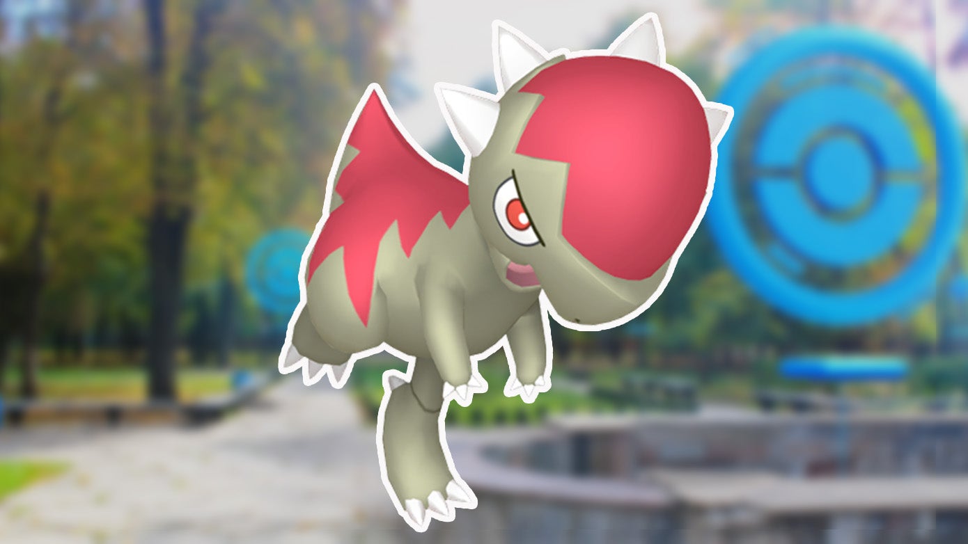 Shiny Cranidos, a dinosaur-themed Pokémon, on a park background from Pokémon Go.