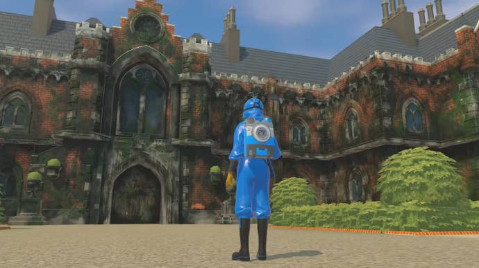 A screenshot from PowerWash Simulator’s Tomb Raider expansion showing a blue-clad cleaner standing in front of Croft Manor