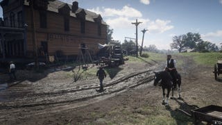 Arthur sits on horseback outside of Saints Hotel in Valentine in Red Dead Redemption 2