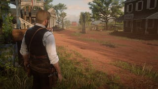 Arthur stands at the side of the road in Rhodes in Red Dead Redemption 2
