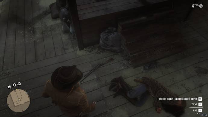 Arthur looks down at the rare rolling back rifle on the ground after killing the man wielding it in a barn in Red Dead Redemption 2