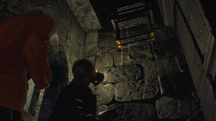 Leon looks up at a collapsible ladder inthe Church in Resident Evil 4 Remake