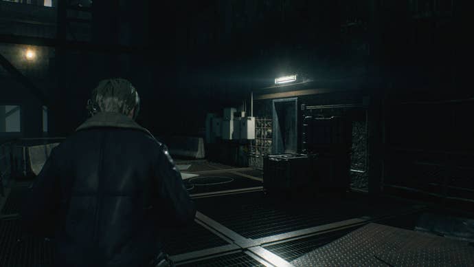Leon looks toward a facility door with a landmine in front of it in Resident Evil 4 Remake