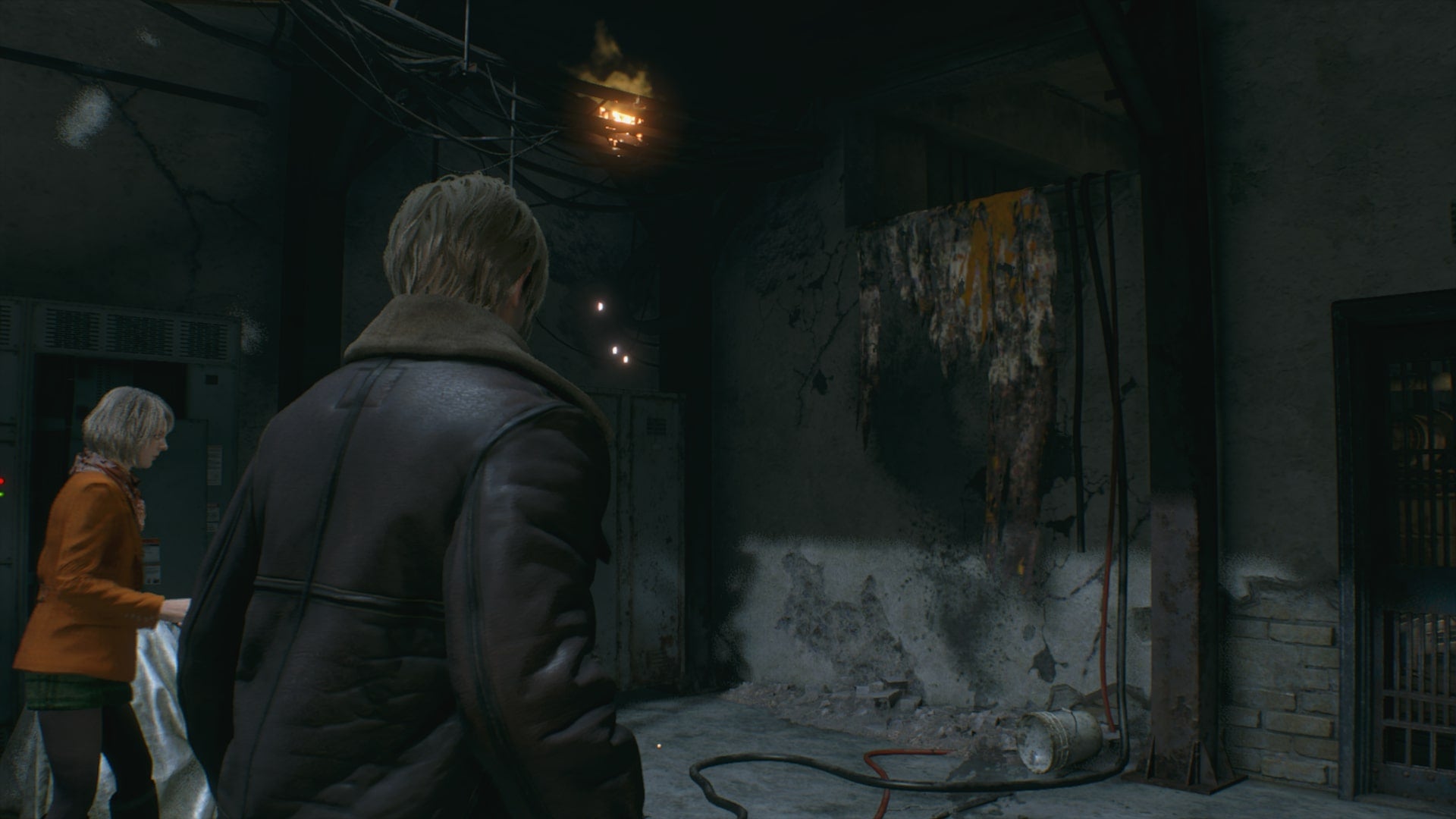 Leon and Ashley look at a gap in the wall that Ashley can climb up in Resident Evil 4 Remake - 3