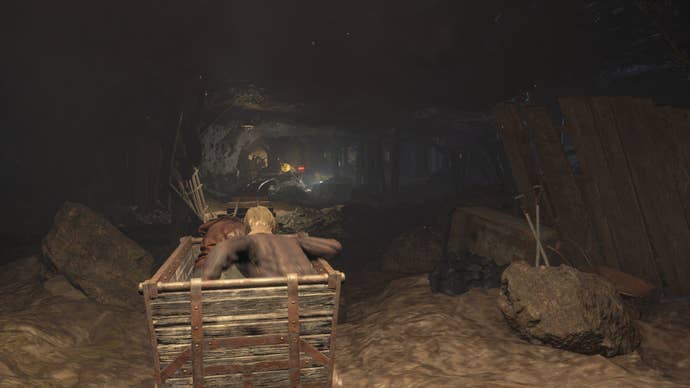 Leon rides a mine cart with Luis through the mines in Resident Evil 4 Remake