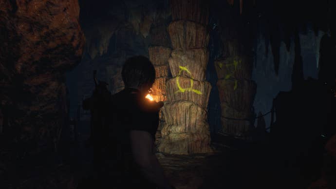Leon shines his torch on a symbol required for the Cave Mural puzzles  in Resident Evil 4 Remake