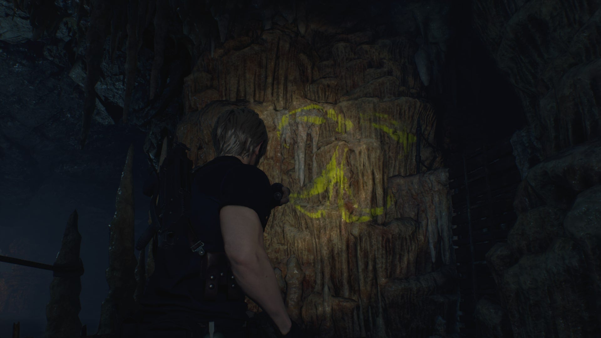 Leon shines his torch on a symbol required for the Cave Mural puzzles  in Resident Evil 4 Remake