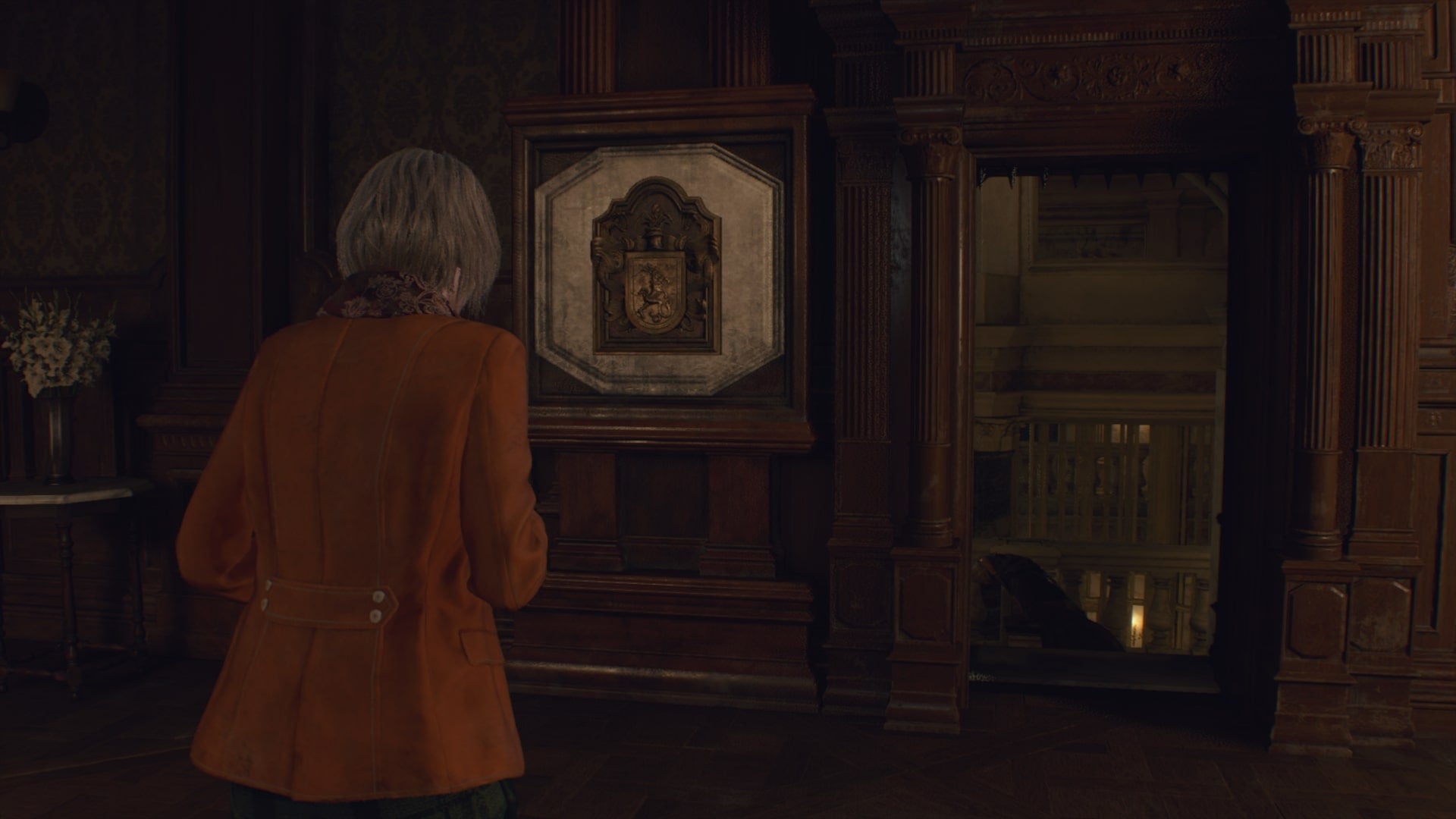 Ashley faces an opened gate after placing the Salazar Family Insignia in Resident Evil 4 Remake