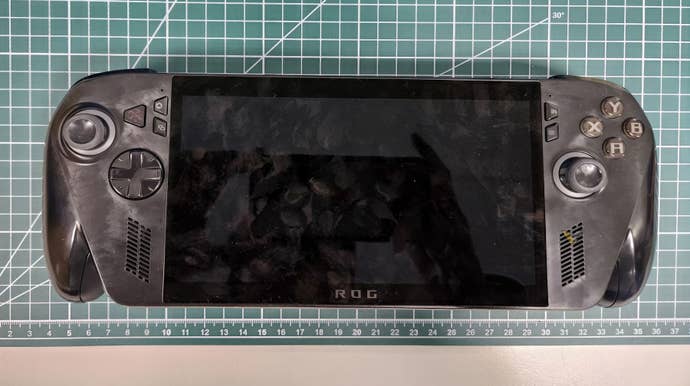 A representation of a achromatic gaming handheld lying connected a desk