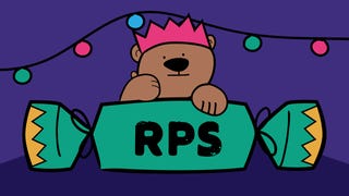 Horace the bear in a lovely paper crown hat, resting his paws on a giant green Christmas Cracker, with RPS printed on it. He's giving you the thumbs up