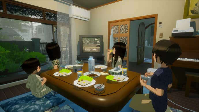 A family sit around a low table eating breakfast in Rainy Season