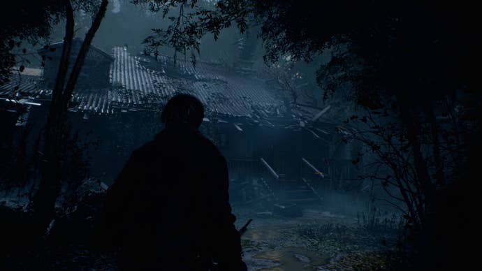 Leon approaches a dark, dilapidated cottage in the Resident Evil 4 remake