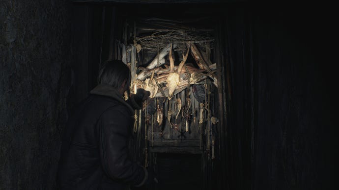 Leon investigates a creepy arrangement of bones in the Resident Evil 4 remake.