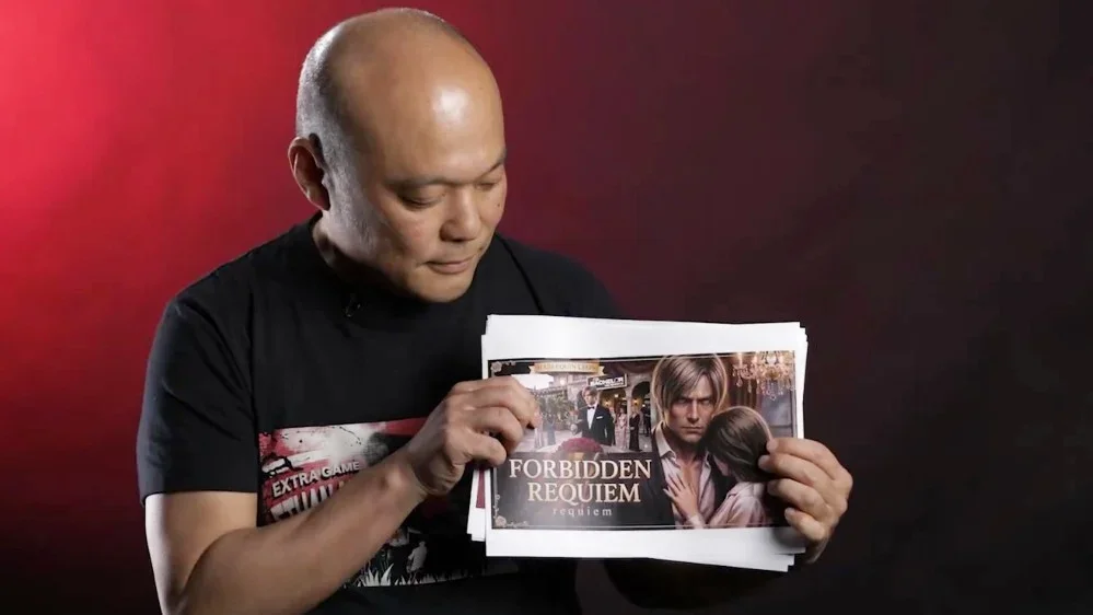 A picture of Resident Evil Requiem director Koshi Nakanishi with a print-out of some spoof Leon Kennedy romance DLC.