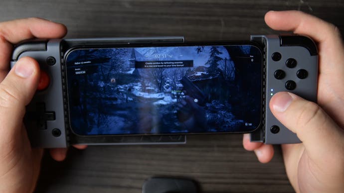 resident evil village running on iPhone 15 Pro, shown using a GameSir X2 slide-in gamepad