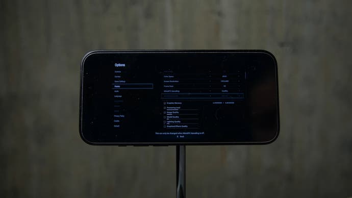 a photo of an iPhone 15 Pro running the Resident Evil Village settings menu