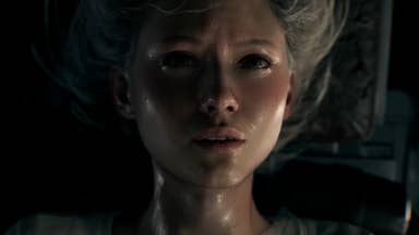 Grace, the lead character from Resident Evil 9, is seen uncomfortable and distressed while strapped upside down to a bed.