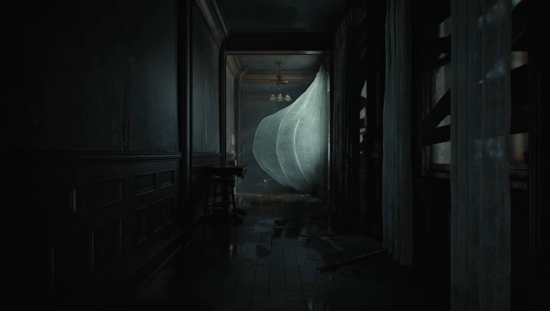 A dark corridor with a curtain blowing in the wind.