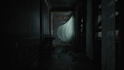 A dark corridor with a curtain blowing in the wind.