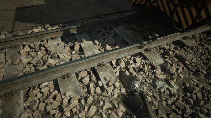 robocop: rogue city screenshot showing nanite and vsm producing a natural environment with pebbles under railway tracks