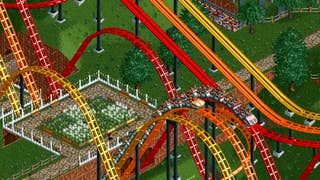 Screenshot of RollerCoaster Tycoon Classic showing competing red, orange, and yellow coasters
