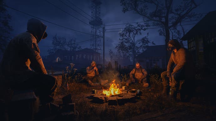 The stalkers gather around a fire in Stalker 2.