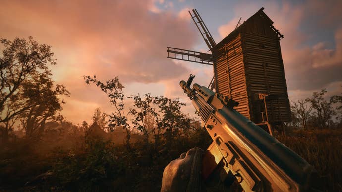 A player raises their gun toward a dusky sky near a windmill in Stalker 2