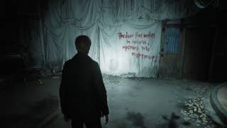 A screenshot from Silent Hill 2 Remake: James stands at the end of a street. It's draped with strange white sheets, a message written them in red: "The door that wakes in darkness, opening into nightmares".