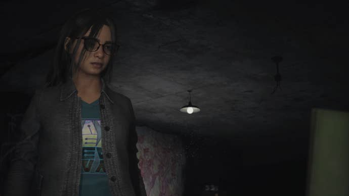 Silent Hill The Short Message Screenshot. Our protagonist, Anita, stares at a board or a call just out of view. She looks sad and worried.