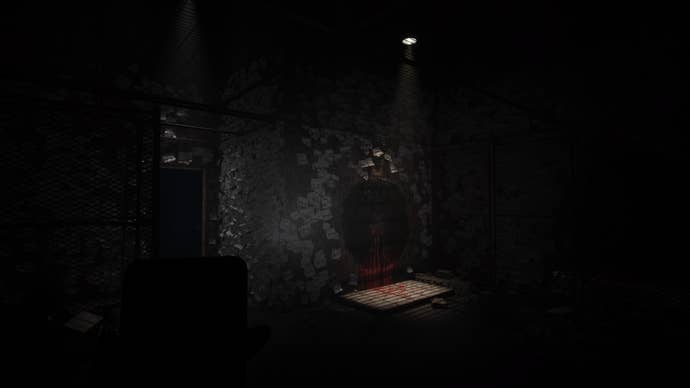 Silent Hill The Short Message Screenshot. A spotlight in a filthy, sticky-note-covered room highlights a crudely drawn hole, not dissimilar to the hole in Henry’s apartment in Silent Hill 4.