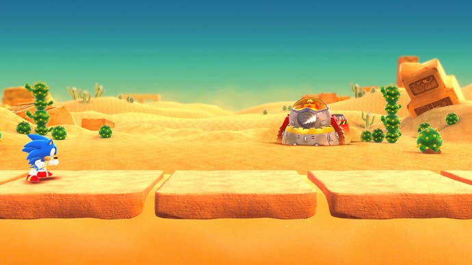 Sonic in a desert level with an Eggman robot in the distance