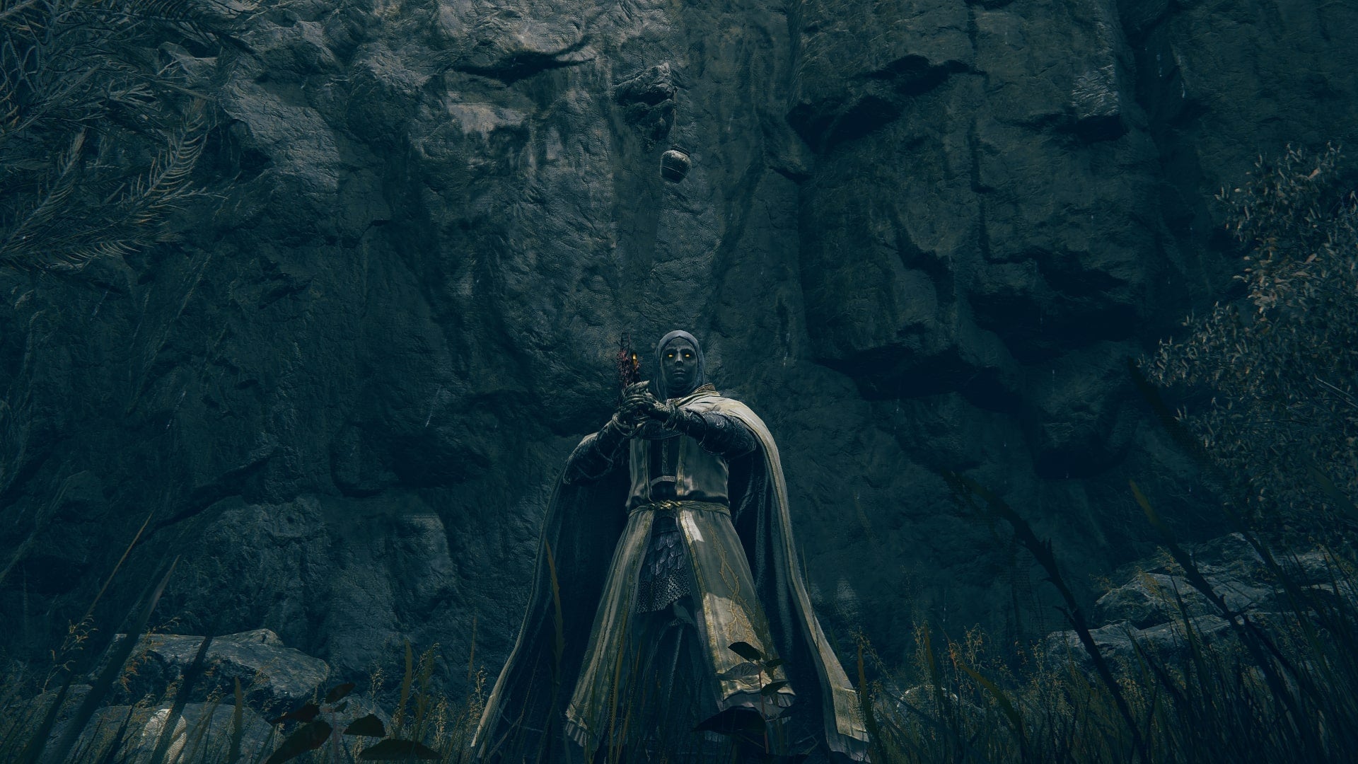 The Tarnished stands in front of a hanging pot that contains a Bell Bearing in Elden Ring Shadow of the Erdtree - 1