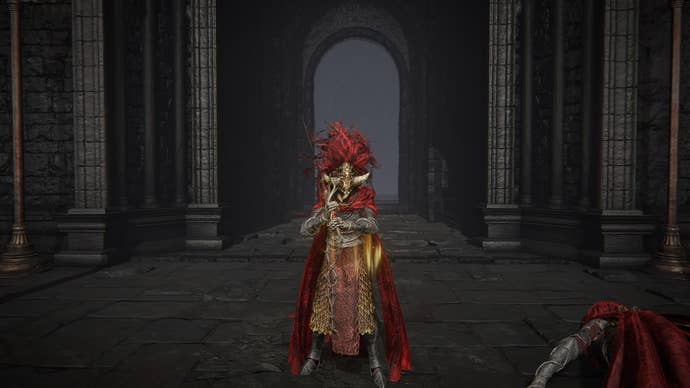 The Tarnished stands in Shadow Keep’s main plaza while wearing Fire Knight armor, Radahn’s helm, and wielding the Fire Knight’s Greatsword in Elden Ring Shadow of the Erdtree