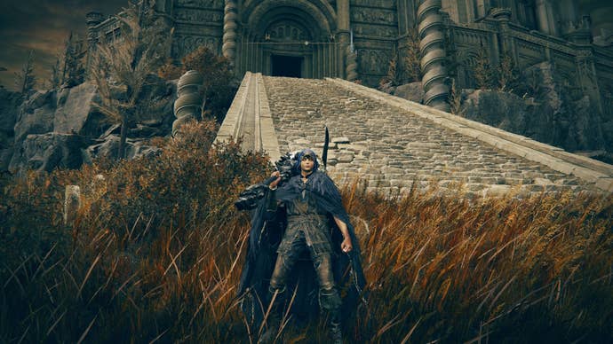 The player stands in front of Belurat Tower Settlement’s entrance in Elden Ring Shadow of the Erdtree