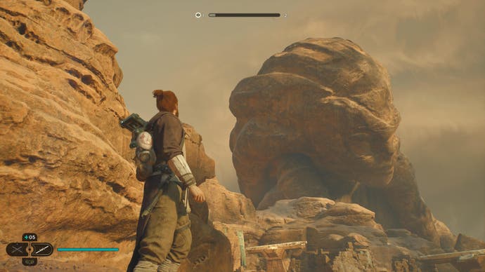 Star Wars Jedi Survivor review - screenshot showing Cal and BD-1 looking up a vast statue on Jedha