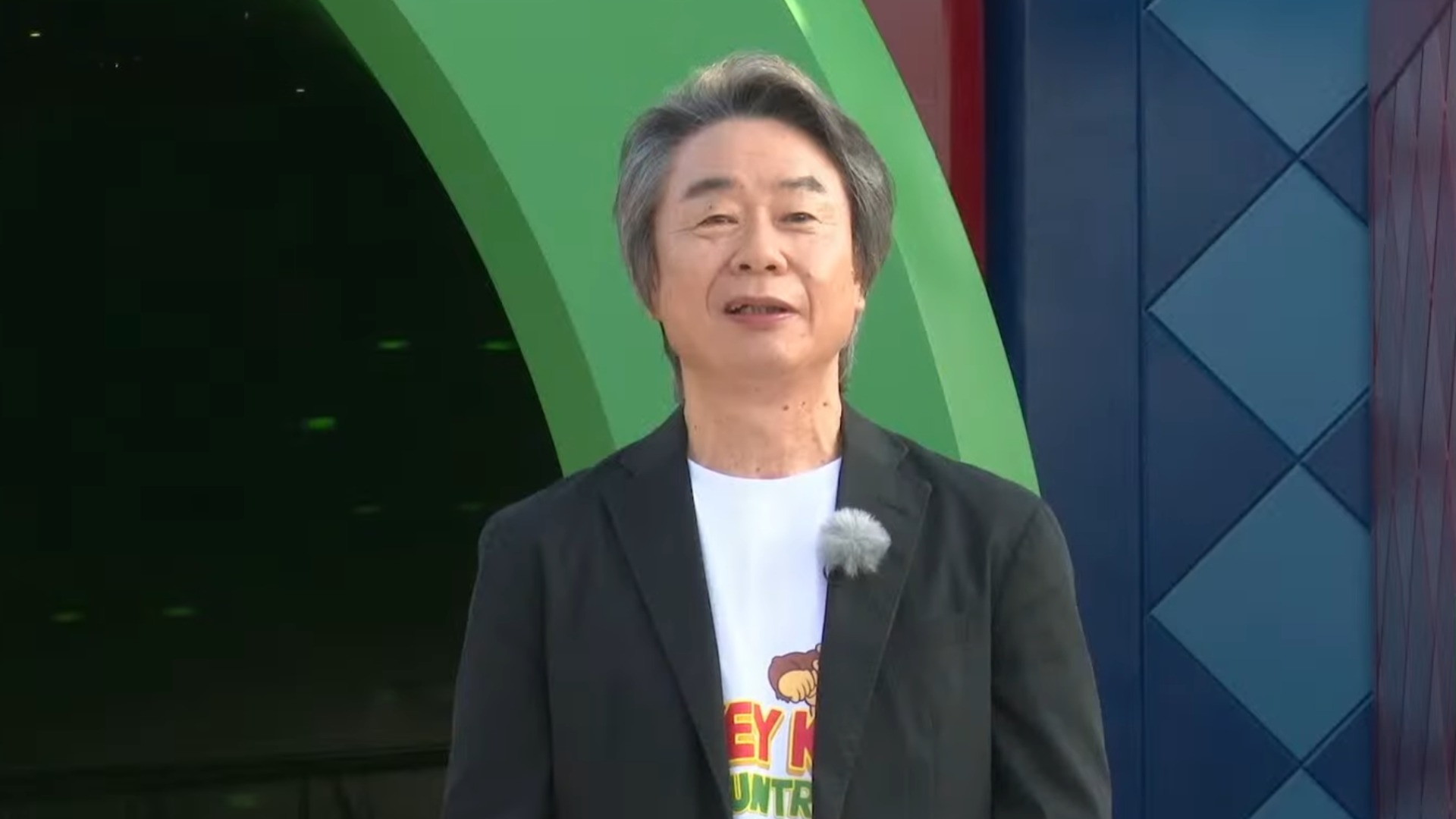 Close up of Shigeru Miyamoto outside Nintendo World theme park from Donkey Kong Country video