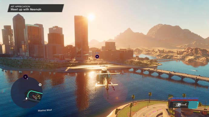 Saints Row review - a wide view of the city across its river at sunset