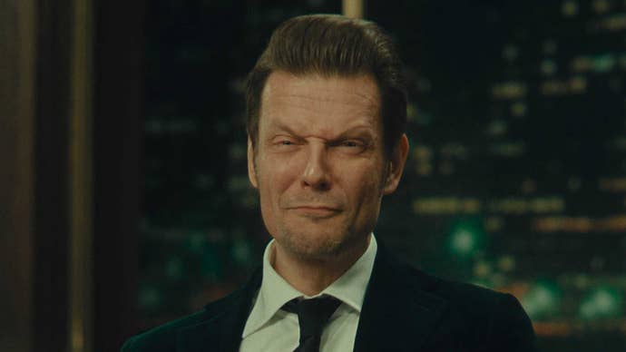 Sam Lake in Alan Wake 2, wearing a suit and tie while pulling funny faces at the camera