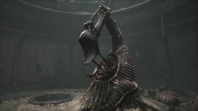 Scorn review - a strange pedestal with a mechanical arm pulls some kind of decaying body out of itself