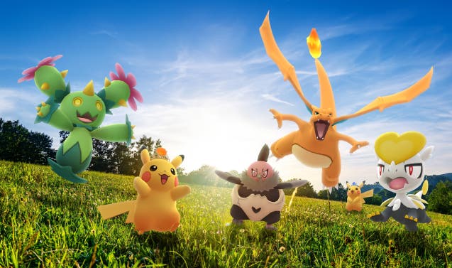 Pokémon including Charizard, Pikachu and Vullaby standing in a green field.