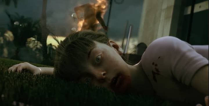 A young girl stares into the camera. There are specks of blood on her t-shirt
