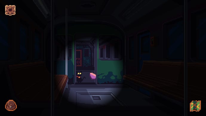 Exploring a dark train car in Devil’s Hideout. A cat is visible in a flashlight’s glow.