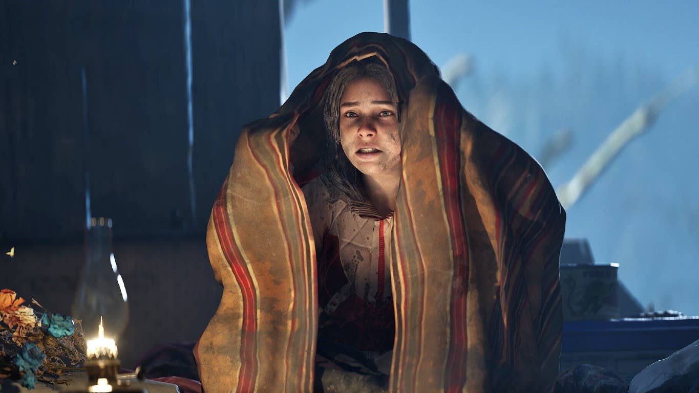 Screenshot for Hell is Us showing a seated female character with a blanket over her head and a gas lamp lighting her face. She looks weary and disheveled